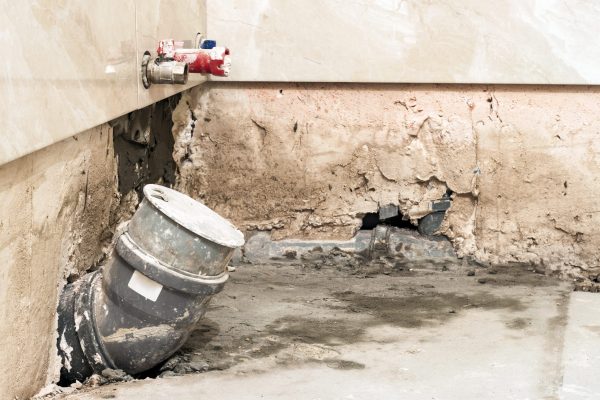 House construction and renovating, pipes and plumbing tools. Bathroom details with installation of pipes. Installing pipes for water supply, heating, sanitation. Workplace plumbing in construction